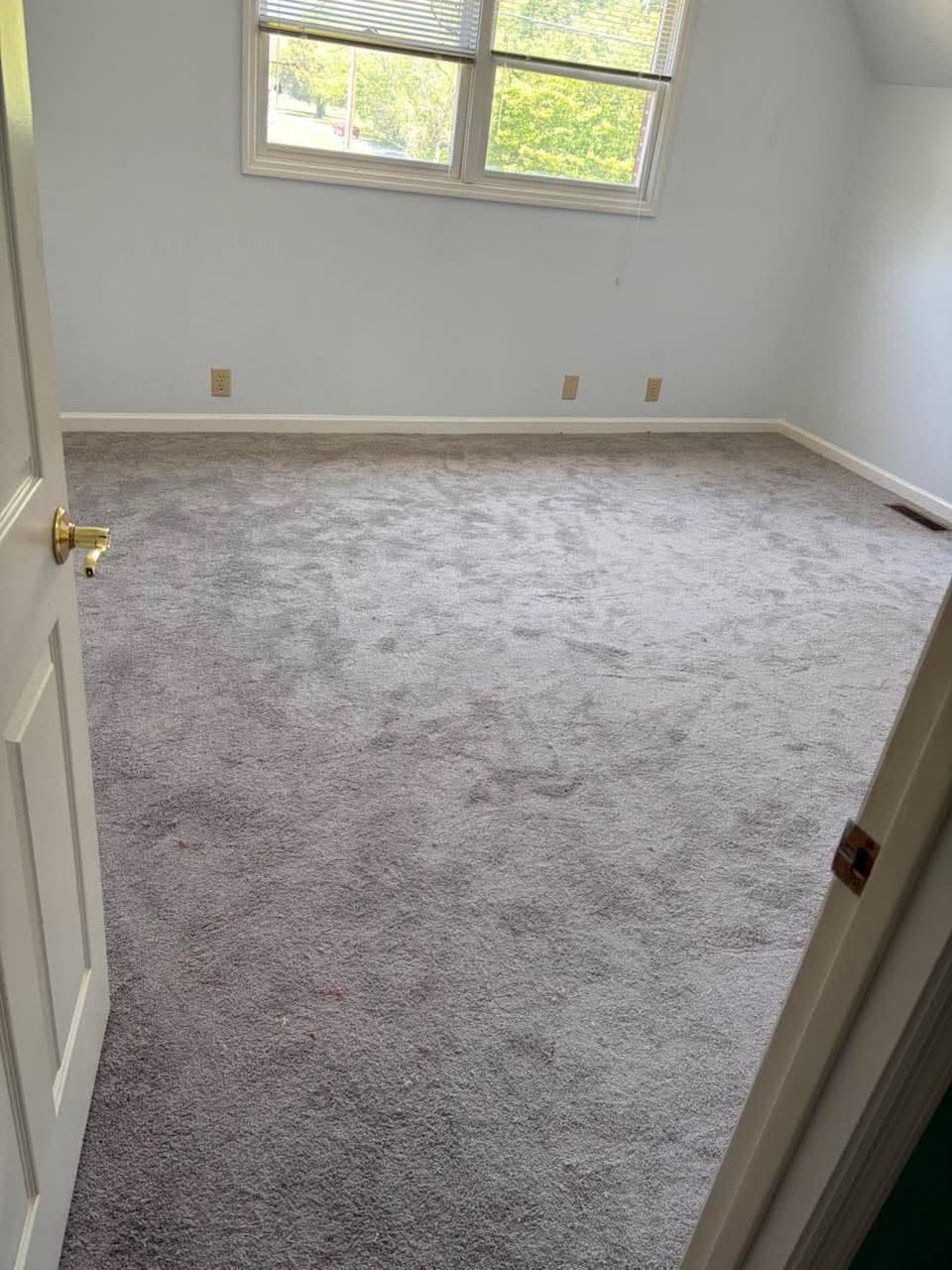 Fresh gray bedroom carpet installation in a bright upstairs room