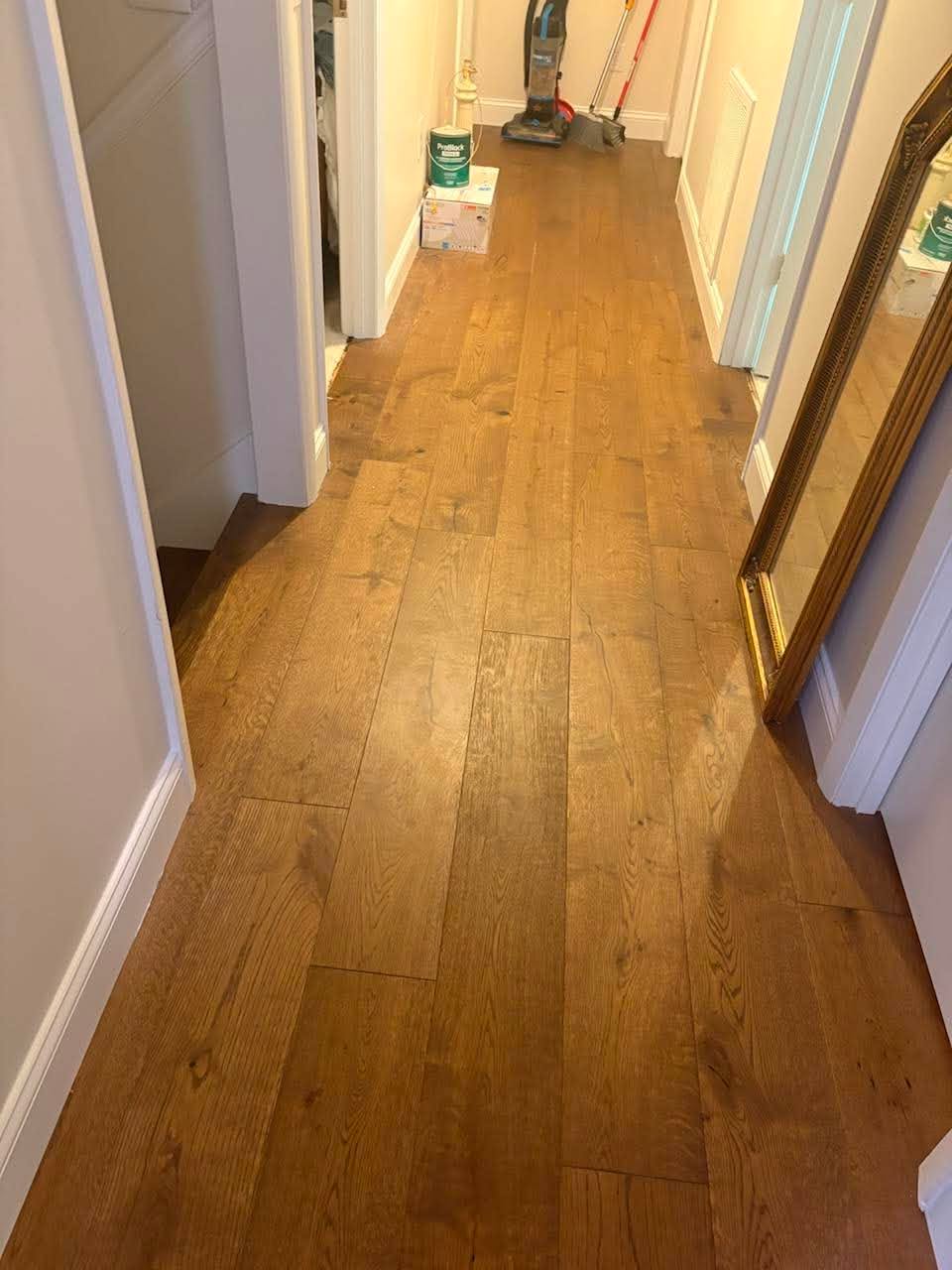 Warm hardwood hallway flooring installation by Jaynes Flooring